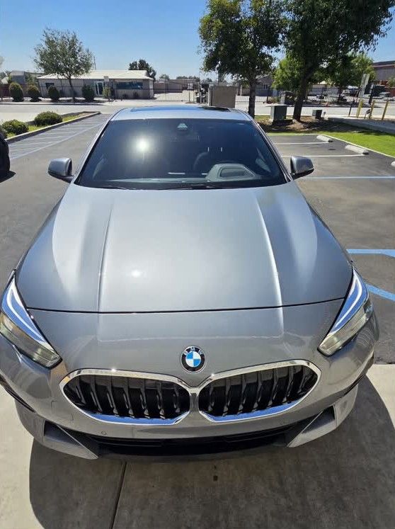 Silver BMW, head-on, freshly detailed